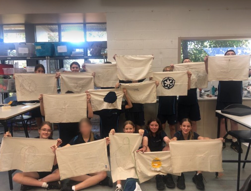 Year 7s holding their tea towels.